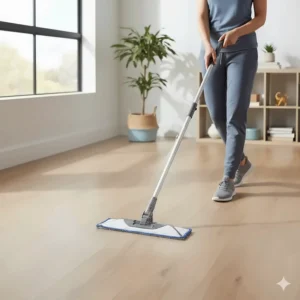 A user demonstrating a spray mop on LVP flooring, emphasizing the convenience and controlled moisture application, which is key to preventing water damage.