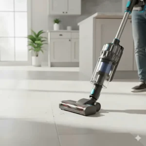 A user effortlessly maneuvering a modern cordless vacuum cleaner across a kitchen's large-format tiled floor for quick, daily cleanups.