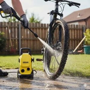 A miniature power washer being used to quickly and effectively blast mud and dirt off mountain bike tires and spokes.