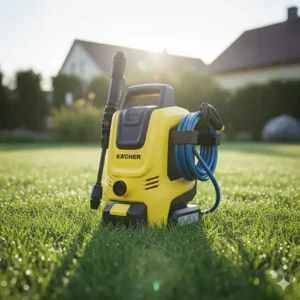 Portable battery-operated miniature power washer resting on a patch of grass, showing its cordless design and compact footprint for easy outdoor use.