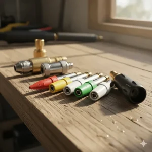 Various colored pressure washer nozzle attachments and tips laid out for selection.