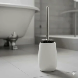 Close-up of a high-quality toilet brush and its decorative caddy, one of the crucial bathroom cleaning utensils.