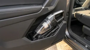 A compact wet dry handheld vacuum for car storage shown tucked neatly into a side door pocket.