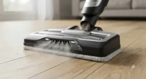 Close-up view of a 2-in-1 steam mop and vacuum combo cleaning head showing simultaneous suction and steam release.