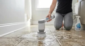 Cordless electric bathroom scrubber for tile and grout on a residential bathroom floor