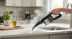 The detachable handheld unit of a 2-in-1 steam mop and vacuum combo sanitizing a kitchen countertop.