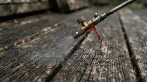 Close-up of a pressure washer nozzle set for multiple surfaces preparing to wash a residential wooden patio deck